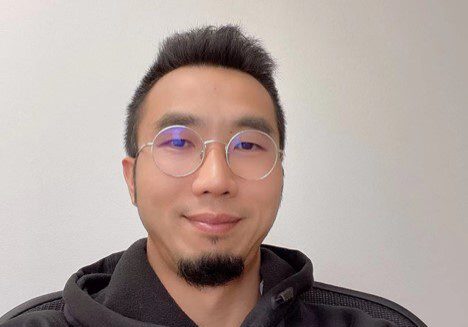 A man with glasses and a beard
